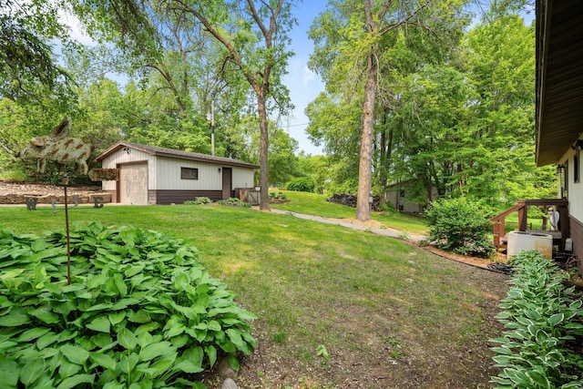 597 Emmet Rd, Lynden Twp, MN 55320 - view of green lawn with an outdoor structure, a garage, and view of scattered trees