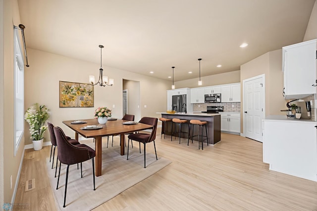 842 Rania Way W, West Fargo, ND 58078 - dining area featuring light wood-style floors, recessed lighting, a chandelier, and baseboards
