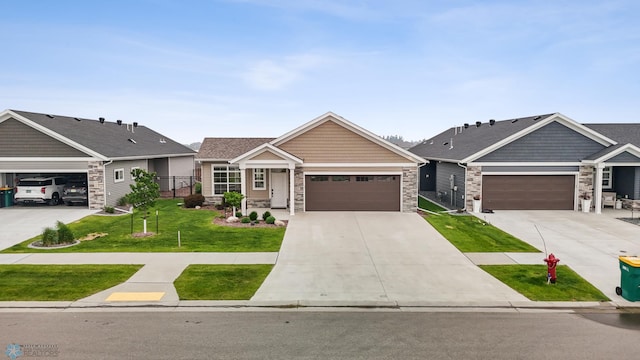 842 Rania Way W, West Fargo, ND 58078 - view of front facade with stone siding, a front lawn, concrete driveway, and an attached garage