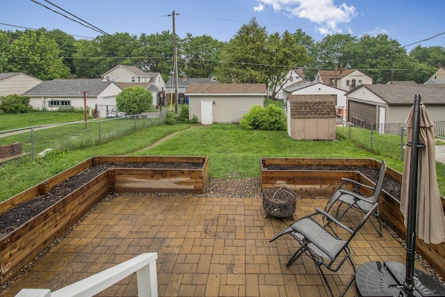 915 Cottage Ave E, Saint Paul, MN 55106 - view of patio featuring a garden and an outdoor fire pit