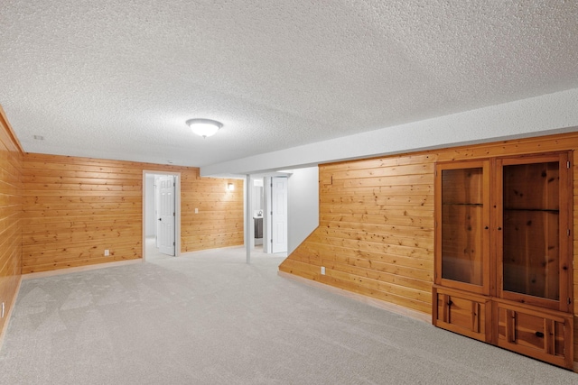 13001 Glenview Dr, Burnsville, MN 55337 - finished basement featuring a textured ceiling, wood walls, and carpet floors