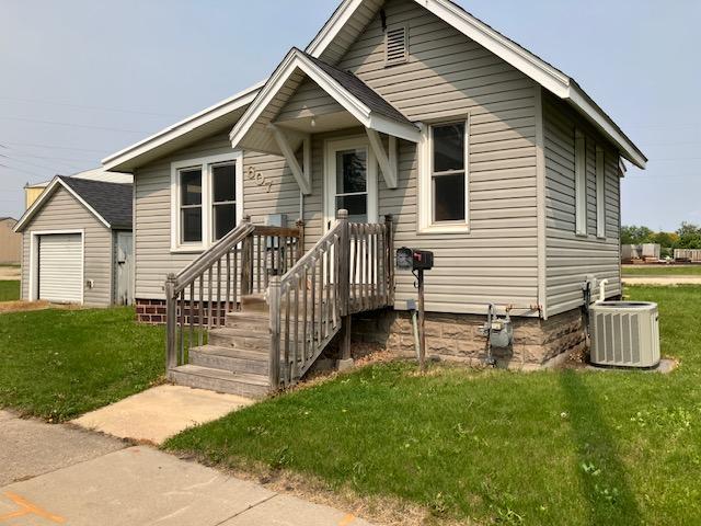 607 3rd St SW, Waseca, MN 56093 - view of front of property with cooling unit and a front lawn