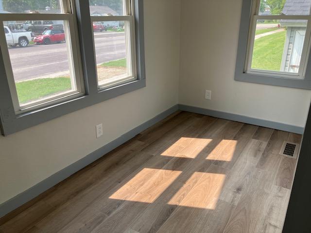 607 3rd St SW, Waseca, MN 56093 - empty room featuring baseboards and wood finished floors