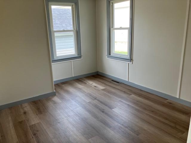 607 3rd St SW, Waseca, MN 56093 - unfurnished room featuring wood finished floors and baseboards