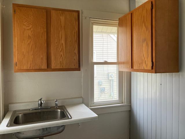 607 3rd St SW, Waseca, MN 56093 - kitchen featuring light countertops, a sink, and brown cabinets