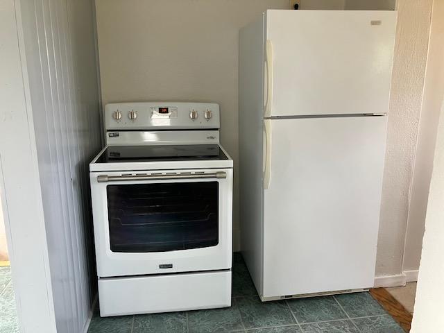 607 3rd St SW, Waseca, MN 56093 - laundry room featuring dark tile patterned floors