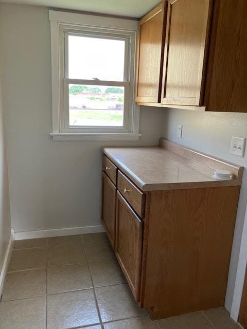 607 3rd St SW, Waseca, MN 56093 - kitchen featuring baseboards, light countertops, and light tile patterned flooring