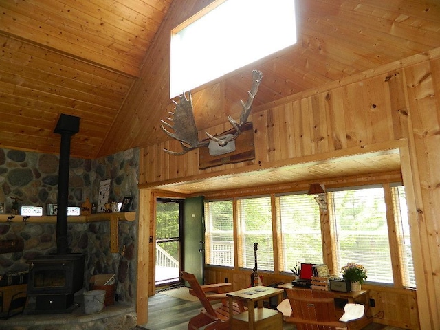 3749 Grizzly Ln, Barnum Twp, MN 55707 - living area with a wood stove, wooden ceiling, high vaulted ceiling, healthy amount of natural light, and wood walls