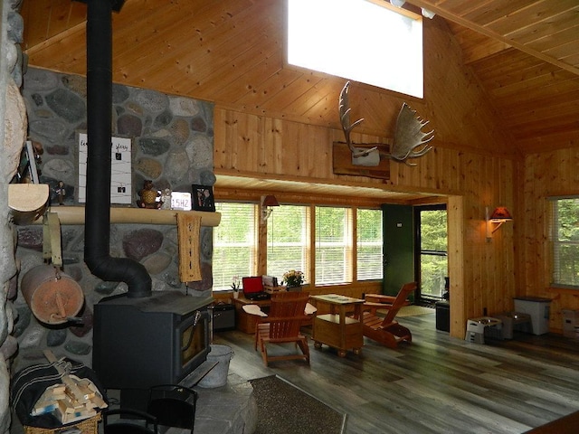 3749 Grizzly Ln, Barnum Twp, MN 55707 - living area featuring a wood stove, high vaulted ceiling, wood finished floors, wooden walls, and wooden ceiling