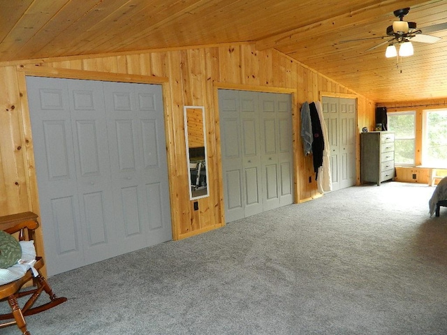 3749 Grizzly Ln, Barnum Twp, MN 55707 - bedroom with lofted ceiling, wooden ceiling, wood walls, multiple closets, and carpet floors