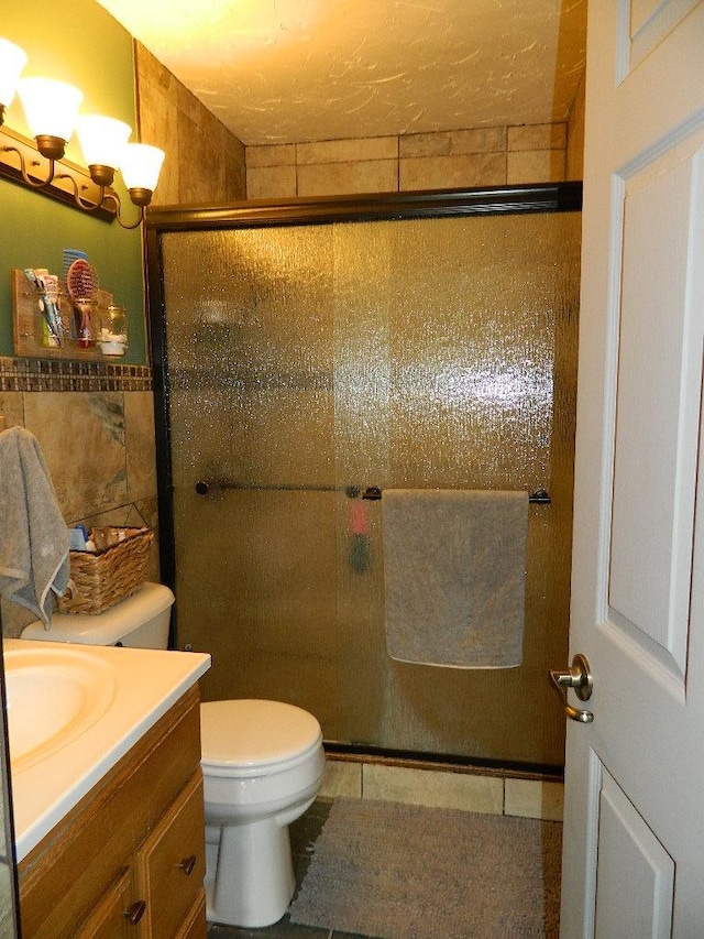 3749 Grizzly Ln, Barnum Twp, MN 55707 - full bath with vanity, a stall shower, toilet, tile patterned floors, and a chandelier