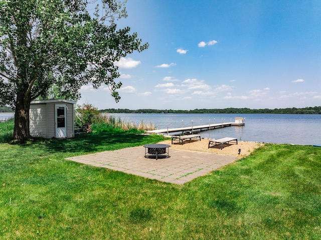 3832 Norris Ave NW, French Lake Twp, MN 55302 - dock featuring a lawn, an outdoor fire pit, a water view, and a patio