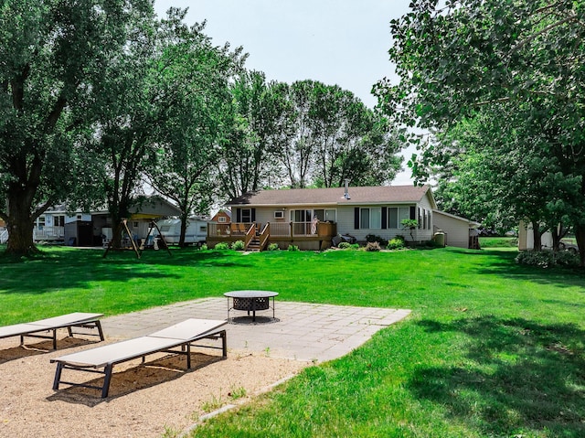 3832 Norris Ave NW, French Lake Twp, MN 55302 - back of property featuring an outdoor fire pit, a deck, a lawn, and a patio
