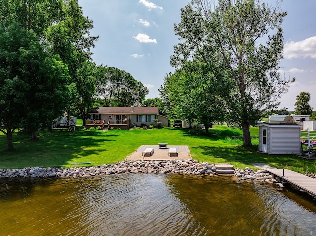 3832 Norris Ave NW, French Lake Twp, MN 55302 - dock area featuring an outdoor fire pit, a yard, a deck with water view, and a patio