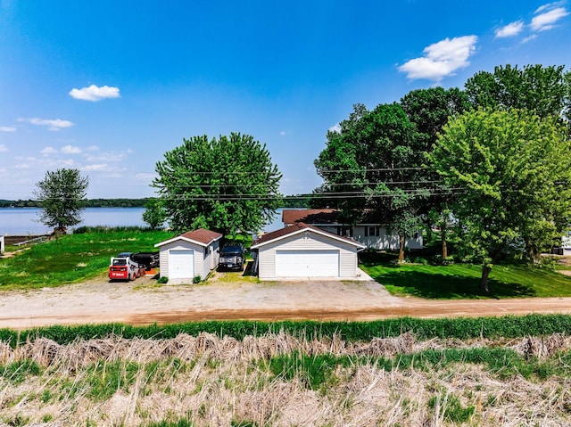 3832 Norris Ave NW, French Lake Twp, MN 55302 - view of front of home with an outbuilding, a detached garage, and a water view