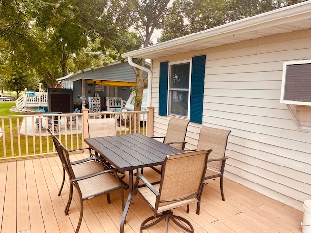 3832 Norris Ave NW, French Lake Twp, MN 55302 - deck featuring outdoor dining area and a lawn