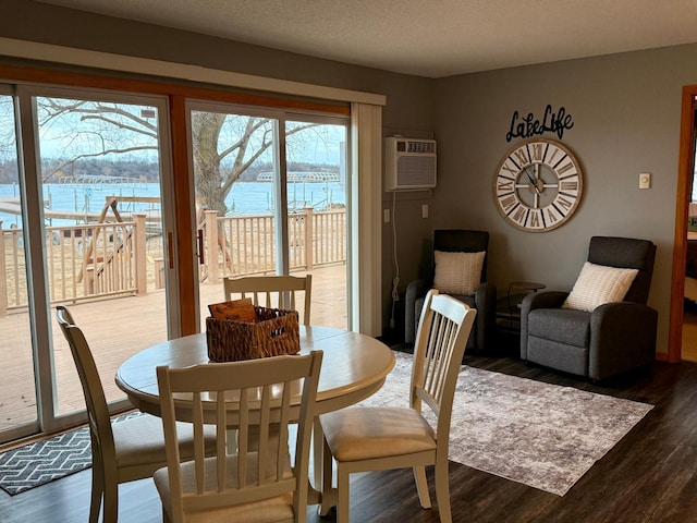 3832 Norris Ave NW, French Lake Twp, MN 55302 - dining area with wood finished floors, a wall mounted air conditioner, and a water view