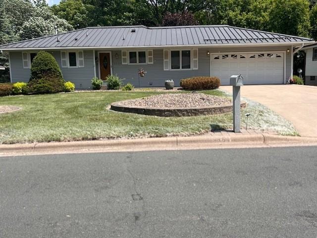 5951 Oakwood Mnr NE, Fridley, MN 55432 - ranch-style house featuring a standing seam roof, a front yard, a garage, concrete driveway, and metal roof