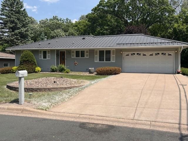 5951 Oakwood Mnr NE, Fridley, MN 55432 - ranch-style house featuring driveway, a garage, a standing seam roof, a front lawn, and metal roof