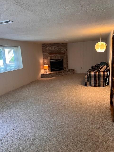 5951 Oakwood Mnr NE, Fridley, MN 55432 - living room featuring a textured ceiling, carpet, and a fireplace