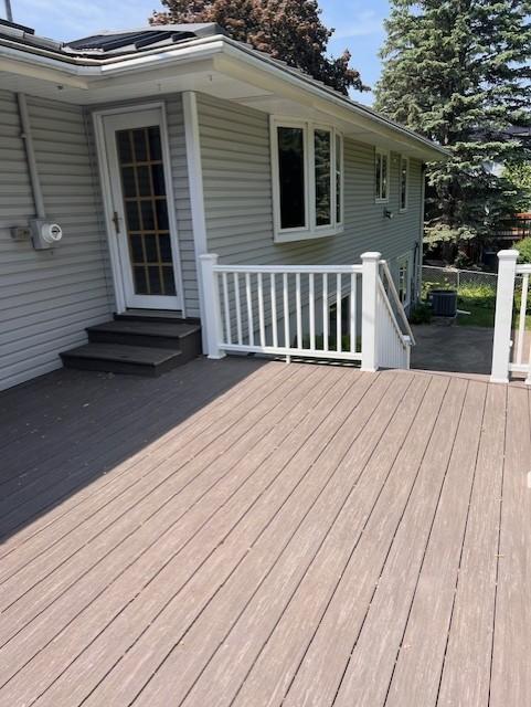 5951 Oakwood Mnr NE, Fridley, MN 55432 - wooden terrace with entry steps and cooling unit
