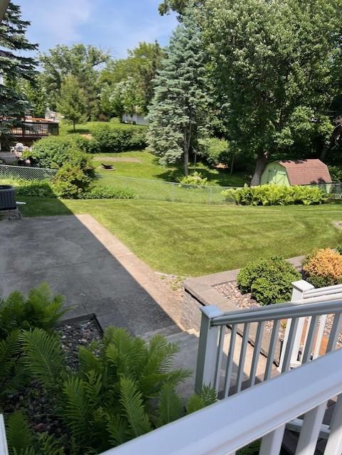 5951 Oakwood Mnr NE, Fridley, MN 55432 - view of grassy yard with a patio and central AC unit