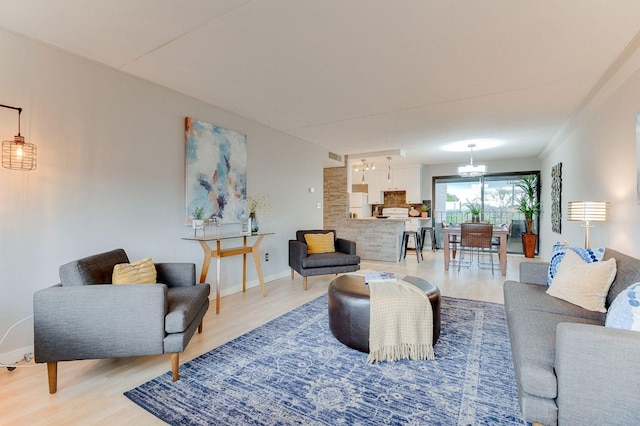 1920 1st St Unit 304, Minneapolis, MN 55454 - living room featuring light wood finished floors, a chandelier, and baseboards