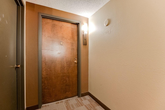 1920 1st St Unit 304, Minneapolis, MN 55454 - corridor with a textured ceiling, a textured wall, and baseboards