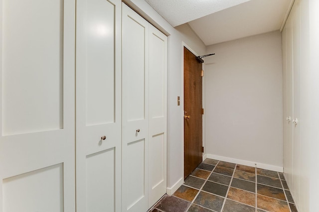 1920 1st St Unit 304, Minneapolis, MN 55454 - hallway featuring dark stone finish floors and baseboards