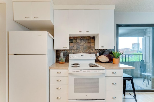 1920 1st St Unit 304, Minneapolis, MN 55454 - kitchen with white appliances, light countertops, backsplash, and white cabinets