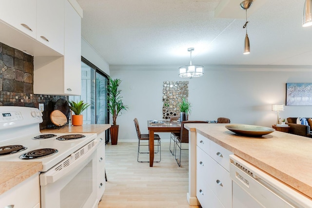 1920 1st St Unit 304, Minneapolis, MN 55454 - kitchen with white appliances, light countertops, hanging light fixtures, light wood finished floors, and white cabinetry