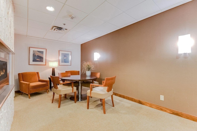 1920 1st St Unit 304, Minneapolis, MN 55454 - dining area featuring carpet, a glass covered fireplace, baseboards, and a paneled ceiling