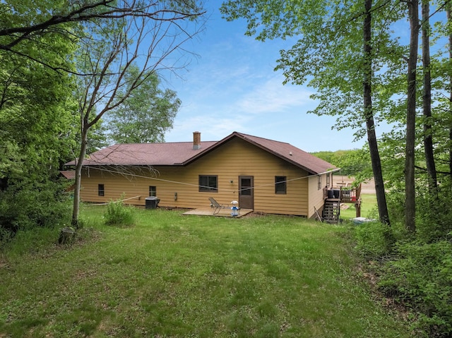 544 22nd St, Sioux Creek Twp, WI 54728 - back of property with a yard, a chimney, a patio, stairway, and a deck