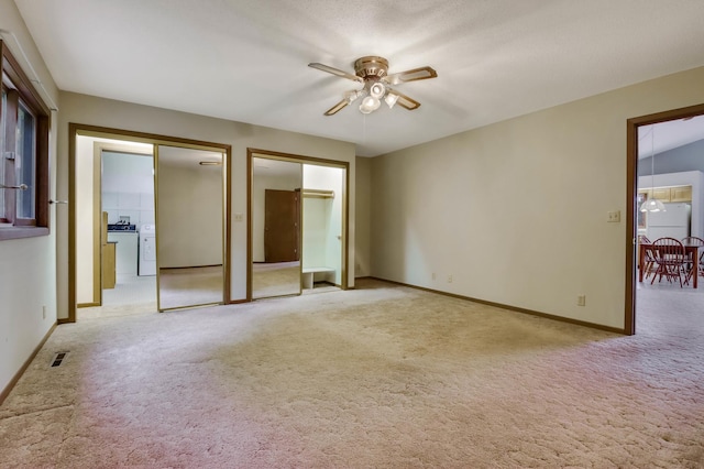 544 22nd St, Sioux Creek Twp, WI 54728 - unfurnished bedroom with light carpet, washer / dryer, baseboards, two closets, and ceiling fan