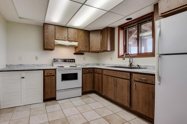 544 22nd St, Sioux Creek Twp, WI 54728 - kitchen with white appliances, under cabinet range hood, a sink, light countertops, and light tile patterned flooring