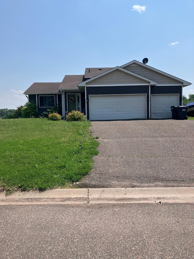 920 9th St, Rush City, MN 55069 - view of front of house with driveway, a garage, and a front yard