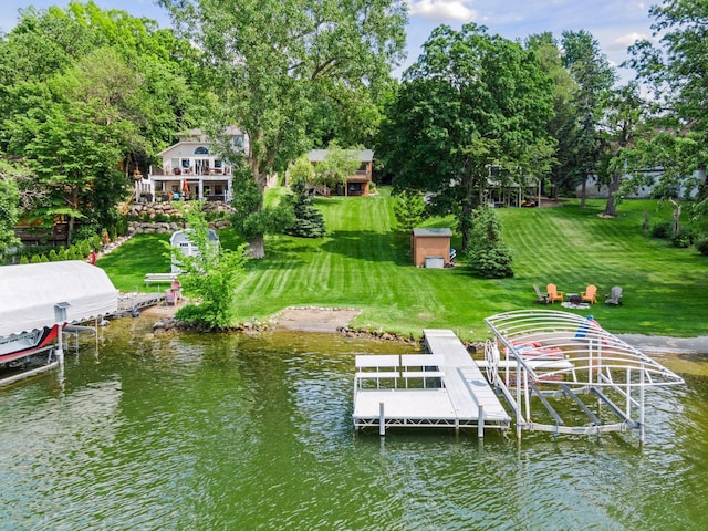 7469 Fernbrook Ln N, Maple Grove, MN 55311 - dock featuring boat lift, a water view, and a yard