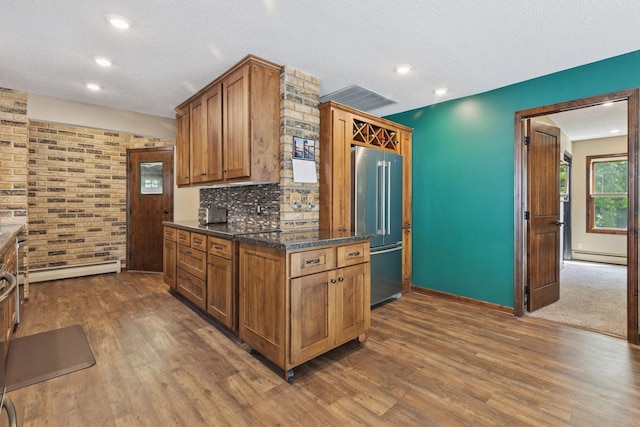 7469 Fernbrook Ln N, Maple Grove, MN 55311 - kitchen featuring high quality fridge, a baseboard heating unit, dark wood-type flooring, baseboards, and a textured ceiling