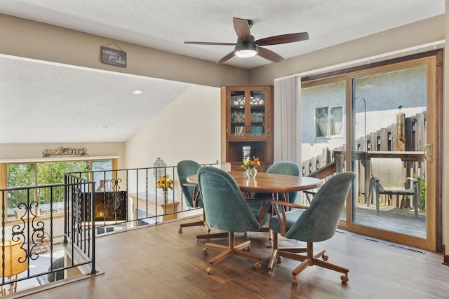 7469 Fernbrook Ln N, Maple Grove, MN 55311 - dining space with a textured ceiling, ceiling fan, and wood finished floors