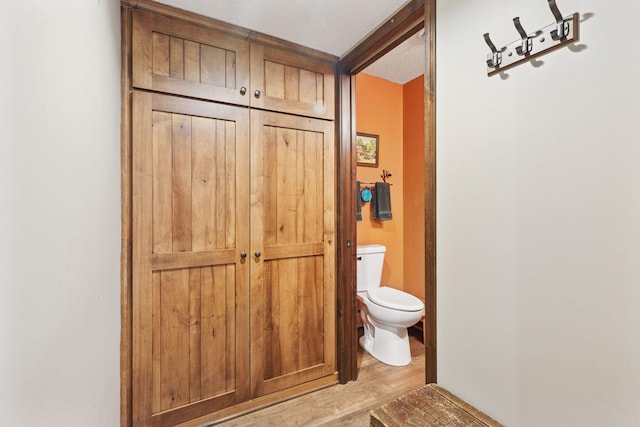 7469 Fernbrook Ln N, Maple Grove, MN 55311 - bathroom with toilet and wood finished floors