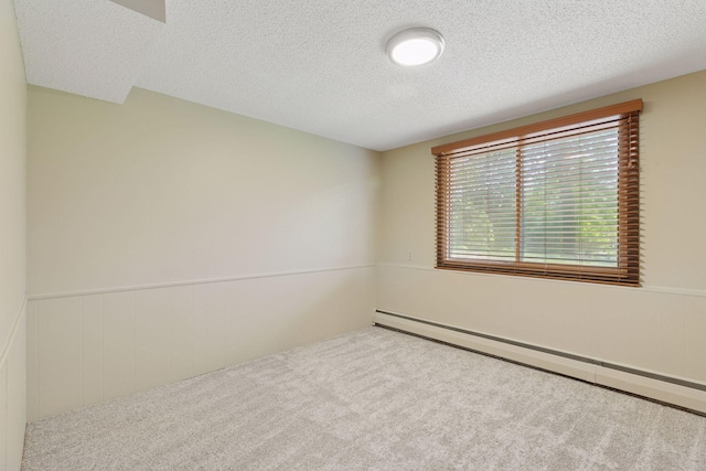 7469 Fernbrook Ln N, Maple Grove, MN 55311 - unfurnished room featuring baseboard heating, carpet, wainscoting, and a textured ceiling