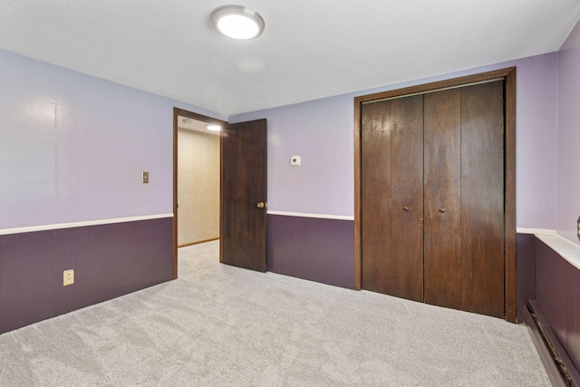 7469 Fernbrook Ln N, Maple Grove, MN 55311 - unfurnished bedroom with carpet, a closet, and a baseboard heating unit