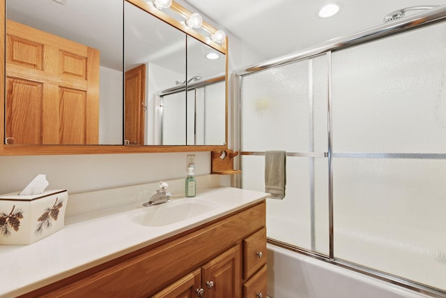 7469 Fernbrook Ln N, Maple Grove, MN 55311 - full bathroom featuring vanity, bath / shower combo with glass door, and recessed lighting