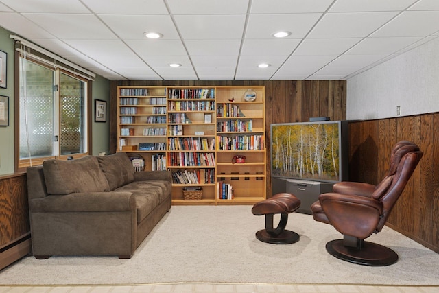 7469 Fernbrook Ln N, Maple Grove, MN 55311 - living area featuring a drop ceiling, baseboard heating, carpet floors, and wooden walls