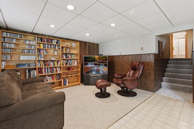 7469 Fernbrook Ln N, Maple Grove, MN 55311 - living area with a drop ceiling, wooden walls, wainscoting, stairway, and recessed lighting