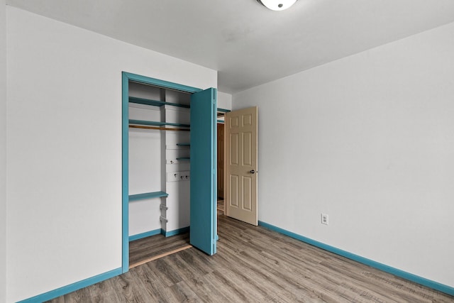1813 Stinson Blvd, New Brighton, MN 55112 - unfurnished bedroom with wood finished floors and a closet