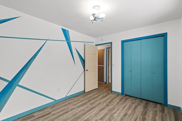 1813 Stinson Blvd, New Brighton, MN 55112 - unfurnished bedroom with wood finished floors and a closet