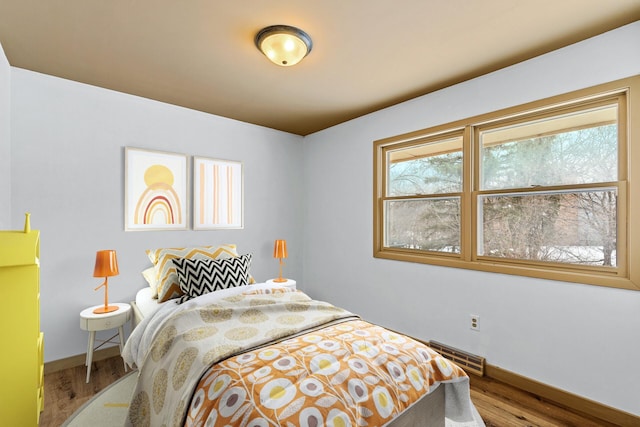 1813 Stinson Blvd, New Brighton, MN 55112 - bedroom with baseboards and wood finished floors