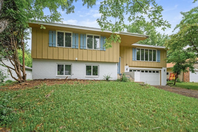 1813 Stinson Blvd, New Brighton, MN 55112 - view of front of house with driveway, a garage, board and batten siding, and brick siding
