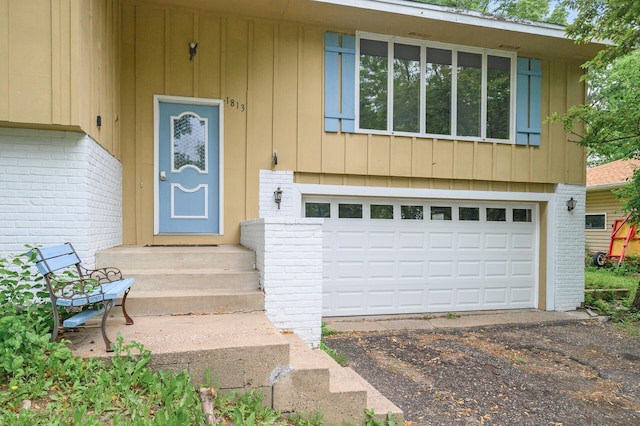 1813 Stinson Blvd, New Brighton, MN 55112 - entrance to property with brick siding, driveway, and a garage
